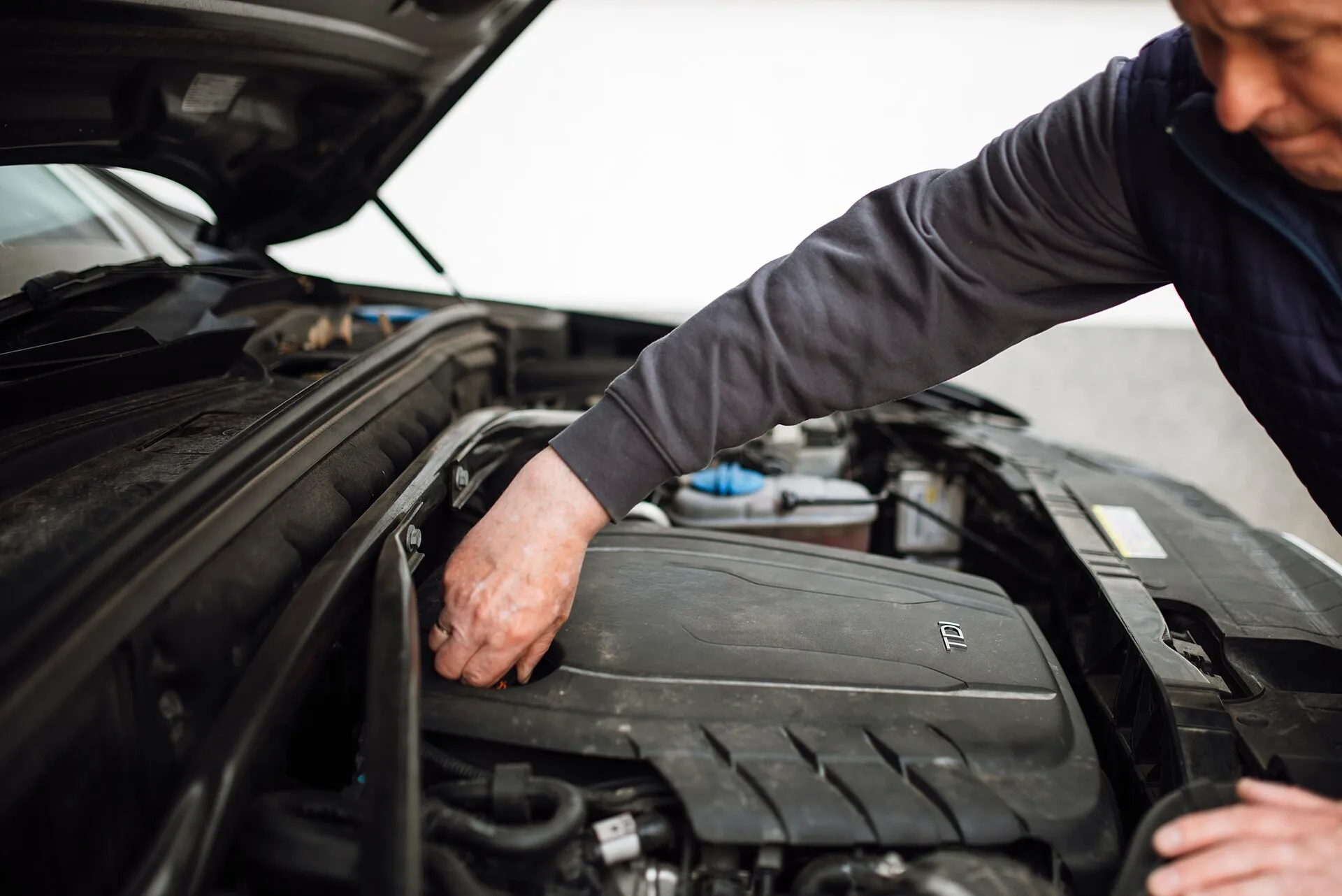 used car inspection mechanic checking engine